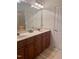 Bathroom with double sink vanity, decorative mirror and lighting, and a glass door shower at 430 Easy Wind Ln, Garner, NC 27529