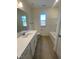 Clean bathroom with a bathtub, vanity, and window at 55 Sawtooth Oak Ln, Youngsville, NC 27596