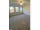 Spacious bedroom with carpeted floors and multiple windows at 55 Sawtooth Oak Ln, Youngsville, NC 27596