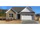 Charming single-story brick home with a two-car garage and well-manicured landscaping at 55 Sawtooth Oak Ln, Youngsville, NC 27596
