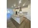 Modern kitchen with large island and granite countertops at 55 Sawtooth Oak Ln, Youngsville, NC 27596