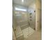 Walk-in shower with built-in seat and glass enclosure at 55 Sawtooth Oak Ln, Youngsville, NC 27596