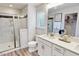 Bright bathroom featuring a glass-enclosed shower, white vanity, and wood-look flooring, creating a modern and clean space at 609 Chopper Ln # Homesite 10, Durham, NC 27703