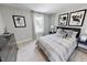 Contemporary bedroom featuring a gray and white patterned comforter, modern art, and neutral walls at 609 Chopper Ln # Homesite 10, Durham, NC 27703