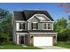 Charming two-story home featuring stone accents, gray siding, and a welcoming front entrance at 609 Chopper Ln # Homesite 10, Durham, NC 27703