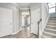 Light-filled hallway with hardwood floors and staircase leading to the upper level at 609 Chopper Ln # Homesite 10, Durham, NC 27703