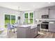 Spacious kitchen with a farmhouse sink and stainless appliances, and an adjacent dining area at 609 Chopper Ln # Homesite 10, Durham, NC 27703
