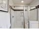 Elegant shower showcasing marble-look tile, a built-in niche, and sleek glass doors, enhancing its spa-like feel at 609 Chopper Ln # Homesite 10, Durham, NC 27703