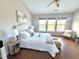 Bright bedroom featuring a vaulted ceiling, a comfortable bed, and three large windows offering backyard views at 610 Canyon Lake Cir, Morrisville, NC 27560