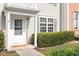 Charming front entrance featuring a storm door, shuttered windows, and manicured landscaping at 610 Canyon Lake Cir, Morrisville, NC 27560