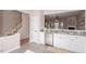 Bright kitchen with stainless steel dishwasher, white cabinets and a view to the adjacent living space at 610 Canyon Lake Cir, Morrisville, NC 27560