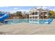 Large community swimming pool with ample deck space and a slide at 610 Canyon Lake Cir, Morrisville, NC 27560