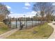 View of the community tennis courts surrounded by sidewalks and mature trees on a sunny day at 610 Canyon Lake Cir, Morrisville, NC 27560