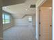 A large bedroom with neutral carpeting and paint, with natural light coming through a large window at 7553 Sweetwater Dr, Nashville, NC 27856