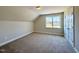 Bright bedroom featuring neutral walls, carpet, and a window, creating a cozy and inviting space at 7553 Sweetwater Dr, Nashville, NC 27856