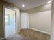 Bedroom with neutral carpet and paint, and has access to a hallway and another room at 7553 Sweetwater Dr, Nashville, NC 27856