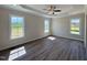 Bright bedroom boasts luxury vinyl floors, abundant natural light, and scenic views from large windows at 7553 Sweetwater Dr, Nashville, NC 27856