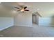 Large bonus room with plush carpet, neutral walls, ceiling fan, and great natural light at 7553 Sweetwater Dr, Nashville, NC 27856