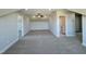 Large bonus room with plush carpet, neutral walls, ceiling fan, and a glimpse of the bathroom at 7553 Sweetwater Dr, Nashville, NC 27856