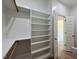 Walk-in closet features generous shelving and hanging space for organized storage solutions at 7553 Sweetwater Dr, Nashville, NC 27856