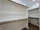 Walk-in closet features generous shelving and hanging space for organized storage solutions at 7553 Sweetwater Dr, Nashville, NC 27856