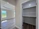 Spacious walk-in closet with ample shelving, offering convenient storage space at 7553 Sweetwater Dr, Nashville, NC 27856