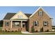 Charming brick home with covered porch and manicured landscaping, offering curb appeal at 7553 Sweetwater Dr, Nashville, NC 27856