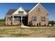 Inviting brick house with complementary shutters and a neatly landscaped yard at 7553 Sweetwater Dr, Nashville, NC 27856