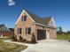 Attached brick garage with a large door and extra lighting providing convenience at 7553 Sweetwater Dr, Nashville, NC 27856