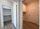 Hallway view showcasing new flooring and adjacent walk-in closet with built-in storage at 7553 Sweetwater Dr, Nashville, NC 27856