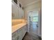 Hallway view featuring white cabinets, quartz countertops, and access to the living room at 7553 Sweetwater Dr, Nashville, NC 27856