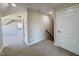 Hallway with carpeted floor gives access to multiple rooms and staircase at 7553 Sweetwater Dr, Nashville, NC 27856