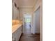 Hallway view featuring white cabinets, quartz countertops, and access to the living room at 7553 Sweetwater Dr, Nashville, NC 27856