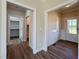 Open hallway featuring hardwood floors and trim, enhanced by stylish lighting fixtures at 7553 Sweetwater Dr, Nashville, NC 27856