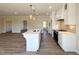 Modern kitchen with white cabinets, stainless steel appliances, and open access to living area at 7553 Sweetwater Dr, Nashville, NC 27856