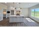Bright kitchen with white cabinets, stainless steel appliances, and a kitchen island at 7553 Sweetwater Dr, Nashville, NC 27856