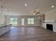 Bright living room with hardwood floors, fireplace, and access to the backyard at 7553 Sweetwater Dr, Nashville, NC 27856