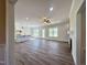 Open-concept living room featuring hardwood floors, a fireplace, and a kitchen island at 7553 Sweetwater Dr, Nashville, NC 27856