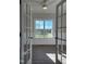 Living room featuring a large window with bright natural light and a neutral interior paint scheme at 7553 Sweetwater Dr, Nashville, NC 27856