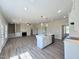 Spacious open concept with kitchen island, living area with fireplace, and light-filled interior at 7553 Sweetwater Dr, Nashville, NC 27856