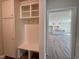 Mudroom with built in bench, storage and view to the kitchen and living room at 7553 Sweetwater Dr, Nashville, NC 27856