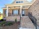 Welcoming front porch with classic columns and a charming brick facade at 7553 Sweetwater Dr, Nashville, NC 27856
