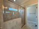 Bathroom features a tile shower with a glass door and window to allow natural light at 7553 Sweetwater Dr, Nashville, NC 27856