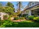 Backyard with mature landscaping, lush green lawn, stone patio, and garage at 205 N Boundary St, Chapel Hill, NC 27514