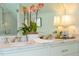 This spacious bathroom has double sinks with marble countertops, a large mirror and stylish lighting at 205 N Boundary St, Chapel Hill, NC 27514