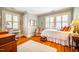 This bedroom features bright hardwood floors, large windows and classic decor at 205 N Boundary St, Chapel Hill, NC 27514