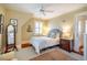 Cozy bedroom with hardwood floors, neutral decor and large windows at 205 N Boundary St, Chapel Hill, NC 27514