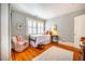 Bright bedroom with hardwood floors, a patterned rug, and large window at 205 N Boundary St, Chapel Hill, NC 27514
