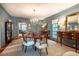 Formal dining room featuring a large round table, chandelier, and neutral-toned walls at 205 N Boundary St, Chapel Hill, NC 27514
