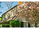Exterior shot of home with blooming pink trees, showcasing the facade and roof at 205 N Boundary St, Chapel Hill, NC 27514